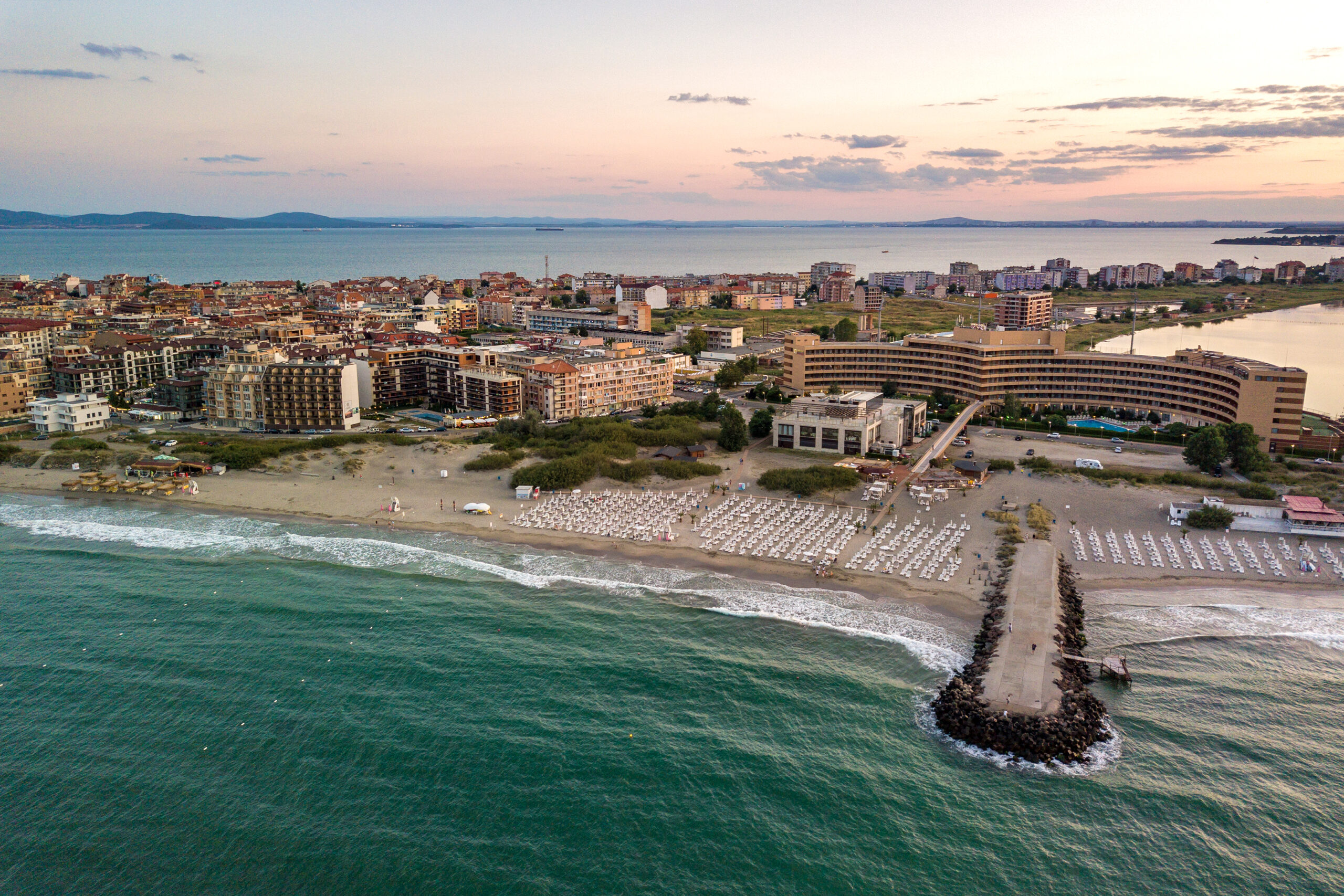 Aerial view of Pomorie city that is located on Black Sea shore. Top view of sand beaches with many hotel buildings and tourist infrastructure.