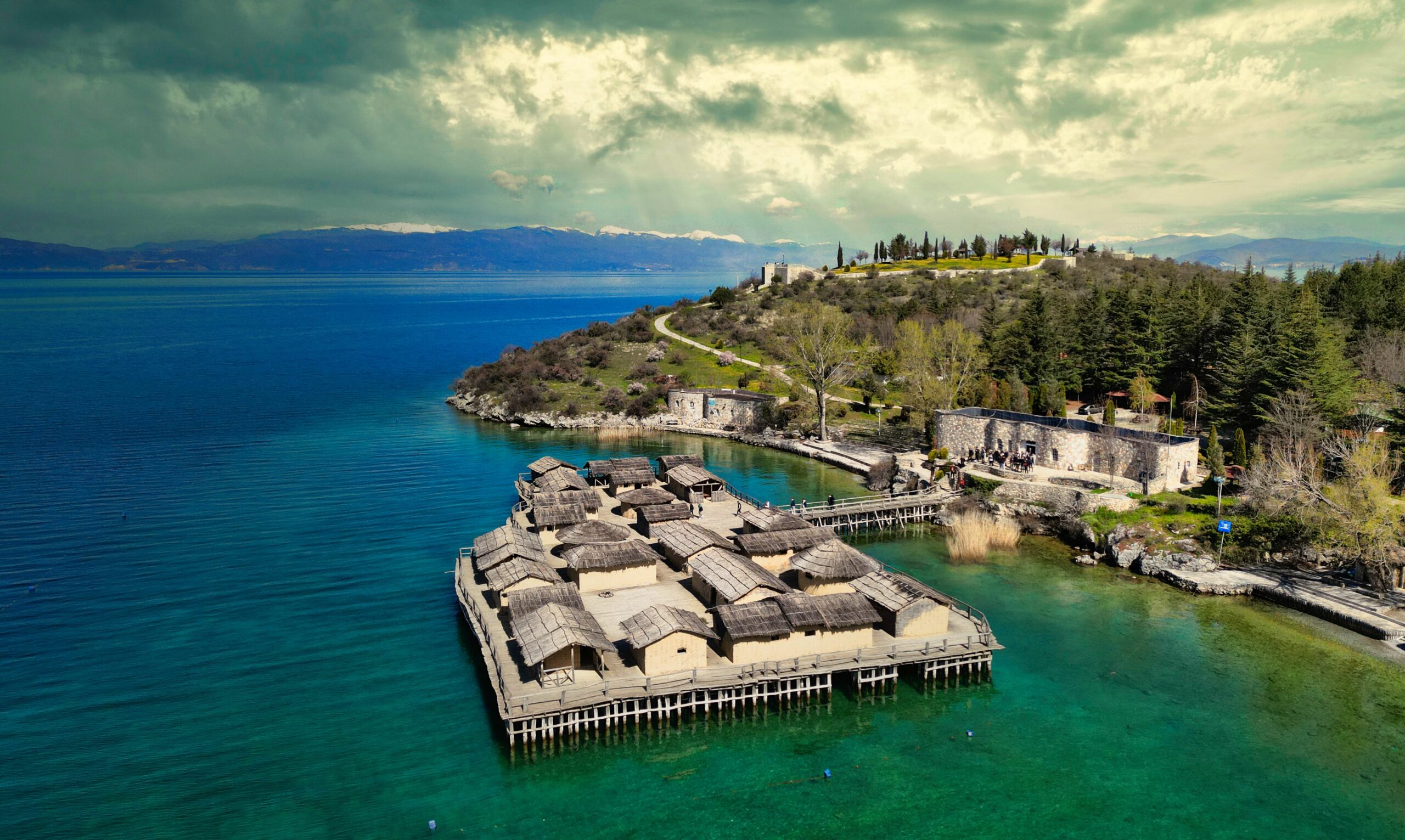Aerial view of wooden structures on the shore with lush greenery. Ohrid, Macedonia.